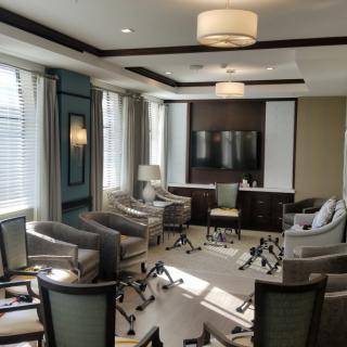 A modern conference room with ample natural light and comfortable seating.