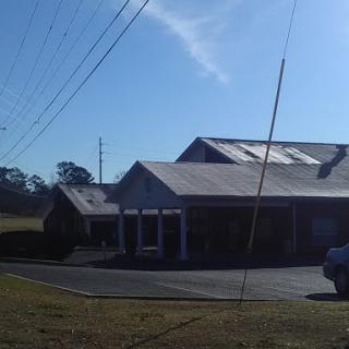 A building featuring solar panels on the roof, captured during a sunny day.