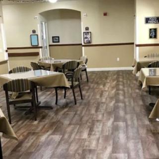 An empty dining area with neatly arranged tables and chairs.