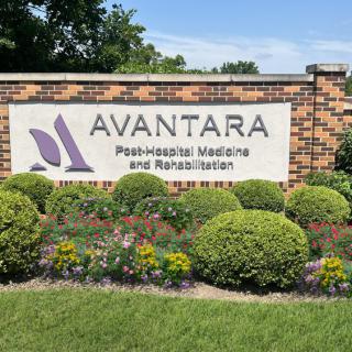 Sign for Avantara, a post-hospital medicine and rehabilitation facility surrounded by landscaped greenery.