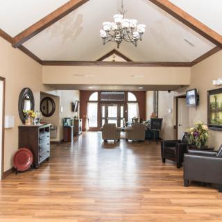 A spacious lobby with a vaulted ceiling, decorated with elegant furniture and lighting.