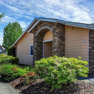 A suburban house with a stone facade and well-maintained landscaping.