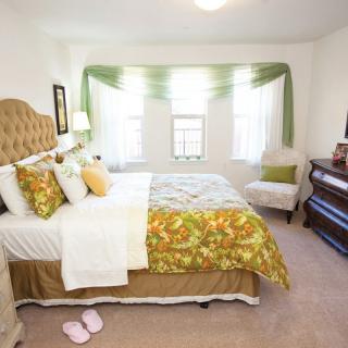 A cozy bedroom with elegant decor and ample natural light.
