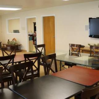 An indoor dining area with tables and chairs arranged neatly.