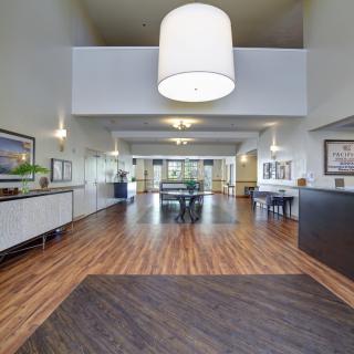 A modern lobby area with stylish lighting and wood flooring.