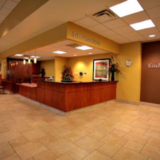 A welcoming reception area featuring wooden furnishings and a bright ambiance.
