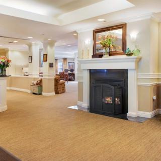 A cozy living room interior featuring a fireplace and elegant decor.