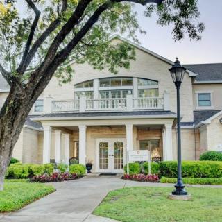 A charming residential building with a well-maintained garden and classic architecture.