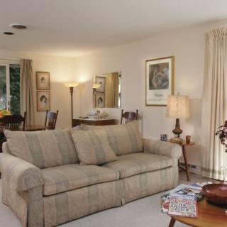 A cozy living room with a comfortable sofa, stylish decor, and ambient lighting.