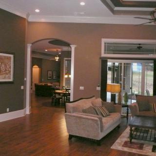 A modern living room with comfortable seating and elegant wooden flooring.
