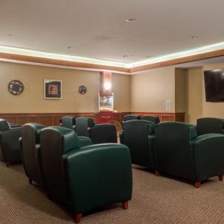 An empty lounge area with arranged seating and wall decorations.