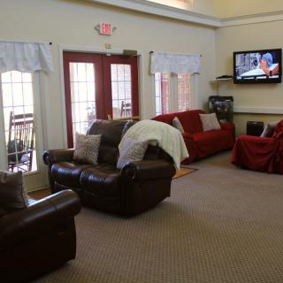 Cozy living room with comfortable seating and a wall-mounted TV.