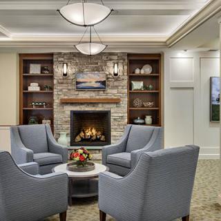 A cozy living room with a modern fireplace and comfortable seating arrangement.