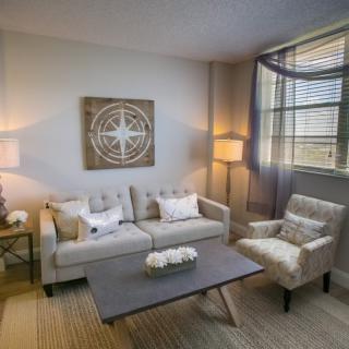A cozy living room with modern decor and neutral tones.