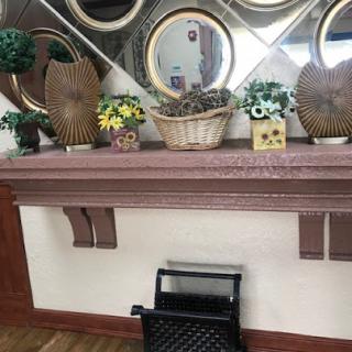 A beautifully arranged shelf with decorative items and mirrors.