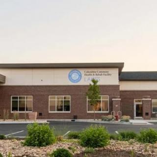 The exterior of a modern medical clinic building under clear skies.