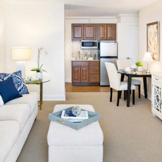 A modern living space featuring a cozy living room, compact kitchen, and dining area.