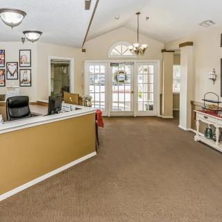 A welcoming reception area with a central desk and decorative elements.