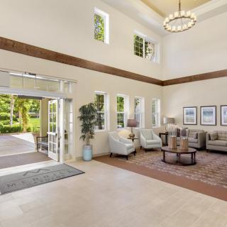 A spacious and bright lobby featuring comfortable seating and elegant decor.