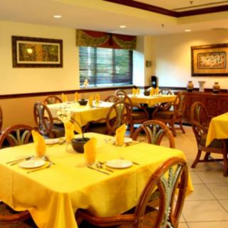 A cozy restaurant dining area with yellow tablecloths and neatly set tables.