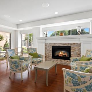 A cozy living room with a fireplace and comfortable seating.