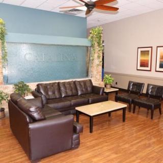 A cozy waiting area with leather seating and decorative elements.