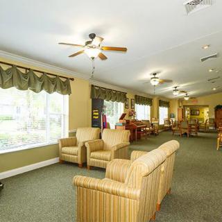 Spacious living area featuring comfortable seating and large windows.