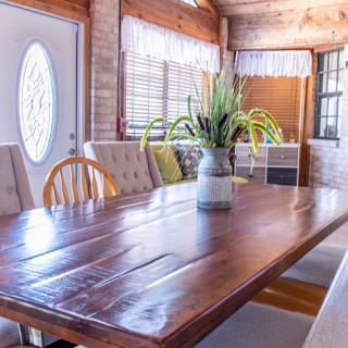 A warm and inviting dining room featuring a large wooden table and natural decor.