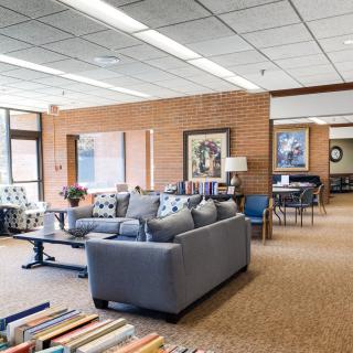 A cozy library interior featuring comfortable seating and bookshelves.