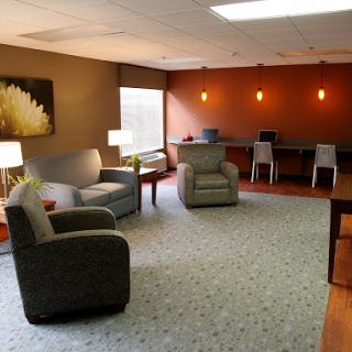 A cozy and modern lounge area featuring comfortable seating and ambient lighting.