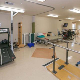 A rehabilitation center equipped with various exercise tools and facilities for physical therapy.