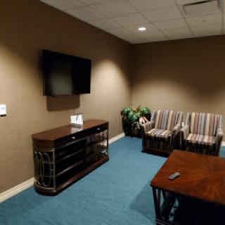 A cozy waiting area featuring comfortable seating and a television.