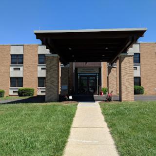 A welcoming entrance to a brick building on a sunny day.