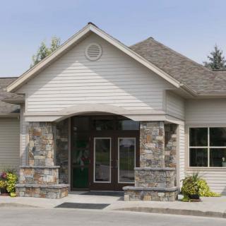 A modern residential building with a stonework entrance.