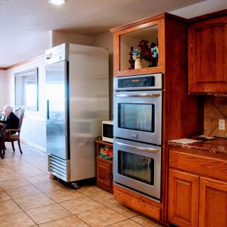 A spacious kitchen with stainless steel appliances and wood cabinetry.