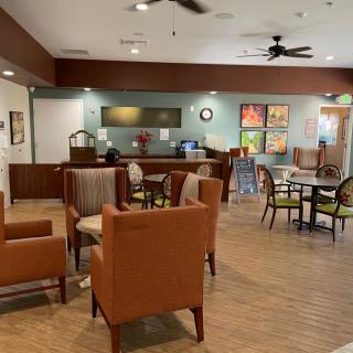 A cozy lobby area with seating and a reception desk in the background.
