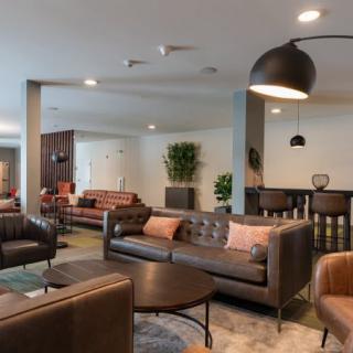 A modern lounge area with stylish sofas and contemporary lighting.