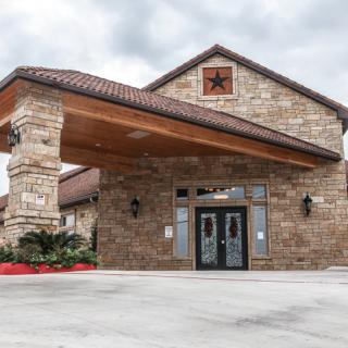 Stone building with a covered entrance and decorative star.