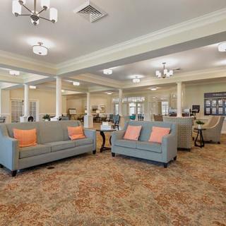 A well-lit lobby with modern sofas and elegant lighting fixtures.