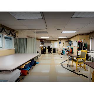 A hospital physical therapy room equipped with various rehabilitation tools and exercise equipment.