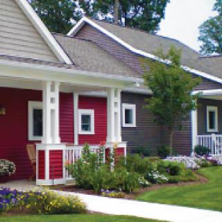 Charming suburban homes with colorful siding and well-maintained gardens.