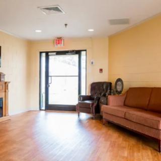 A cozy lobby area with seating and a door leading outside.