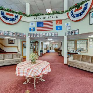 A decorated lobby area featuring a 'Hall of Honor' display with flags and banners.