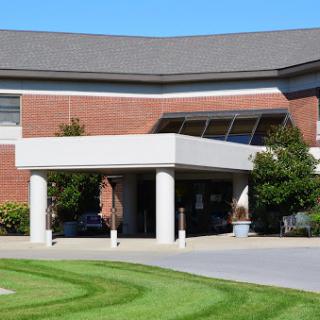 A modern healthcare facility featuring a well-designed entrance and manicured lawns.