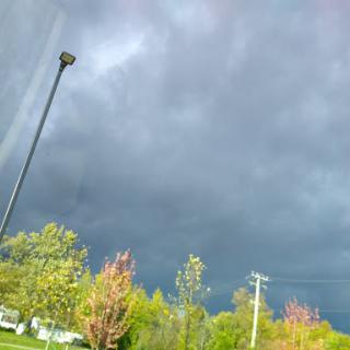 Dark storm clouds loom over the landscape, signaling an approaching storm.