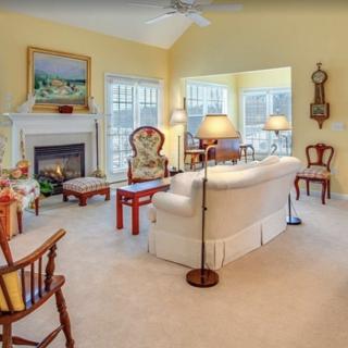 A cozy living room with traditional furniture and a fireplace.