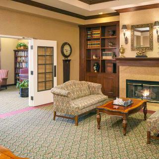 A cozy living room with a fireplace and comfortable seating.