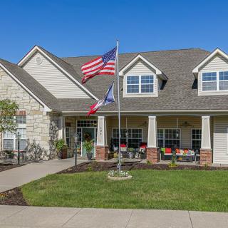 A residential house with American and Texas flags displayed outside.