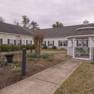 A scenic view of a building with a gazebo and landscaped garden area.