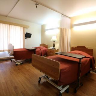 A clean and modern hospital room with two beds.